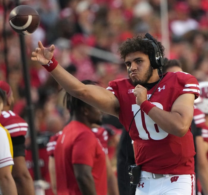 Wisconsin freshman quarterback Myles Burkett warming up on the sidelines.